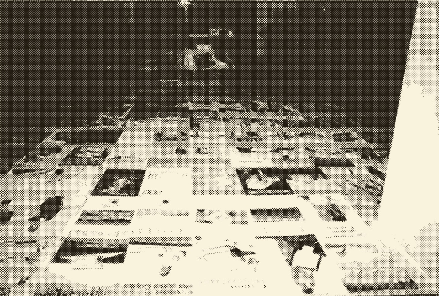 A halftone-screened photograph of a teenager lying on a lounge-room floor behind hundreds of photocopier brochures laid out edge to edge in a grid